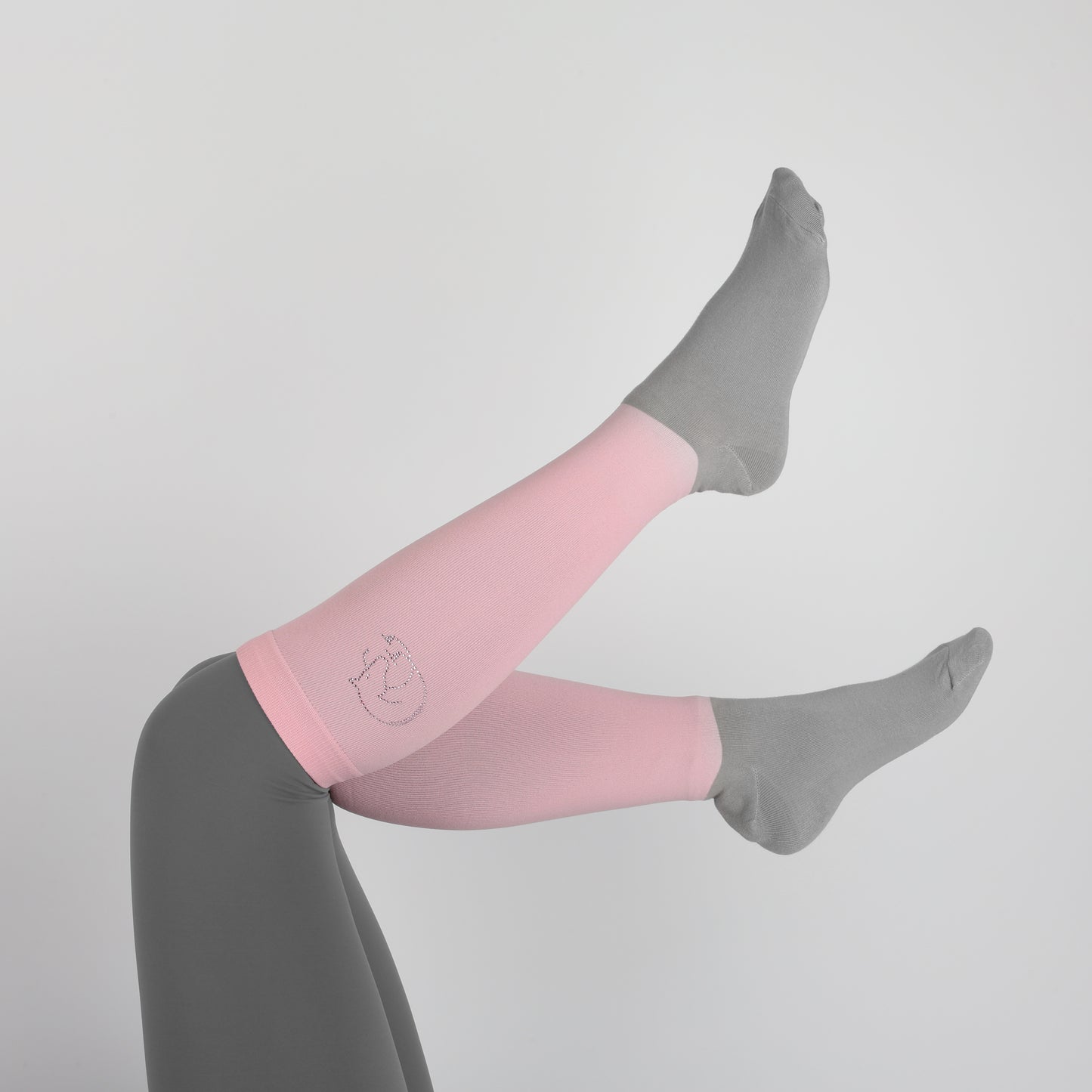 image of a model wearing our pink and grey childrens horse riding socks