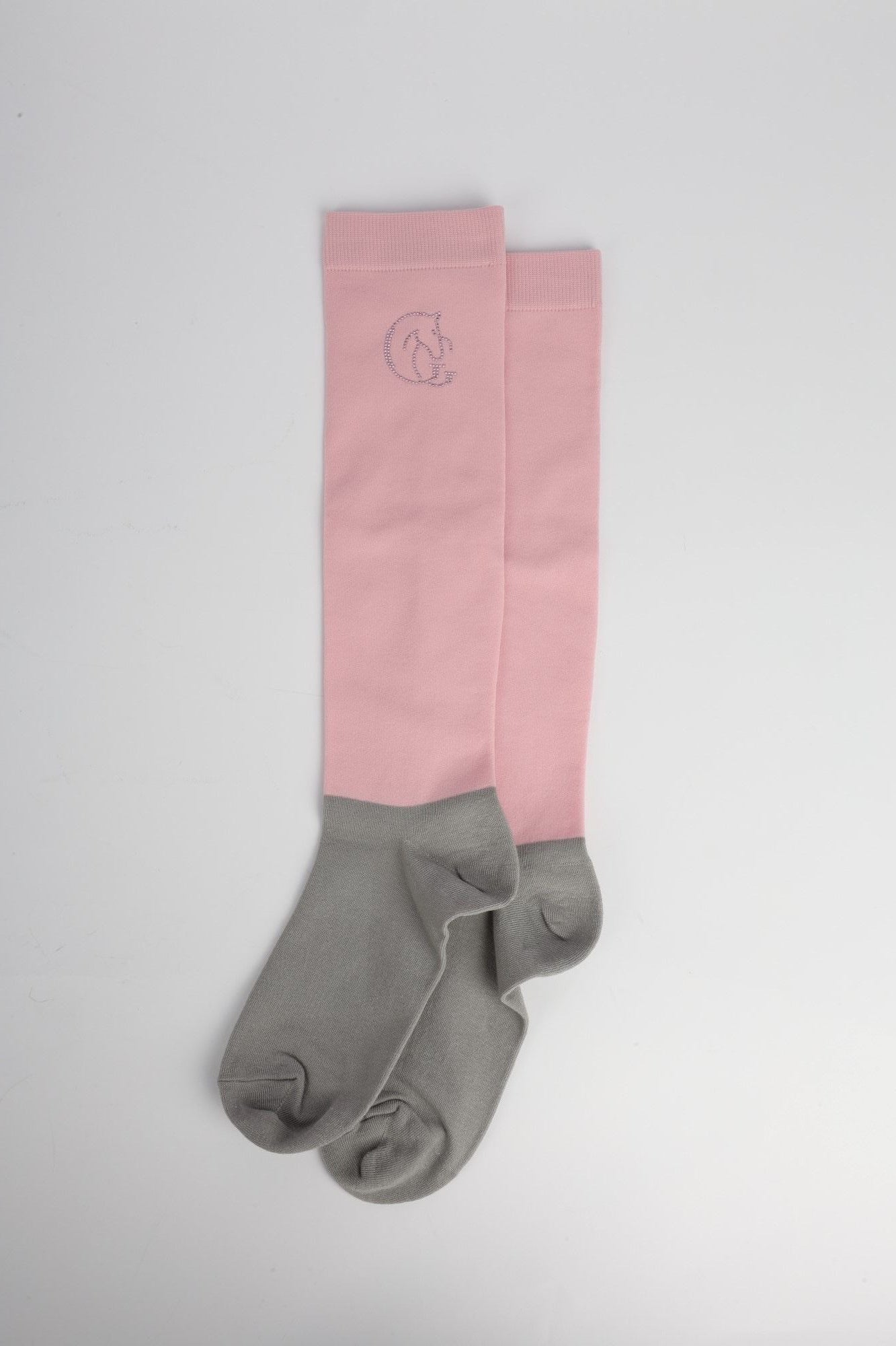 Pink and grey socks with a logo on a light grey background