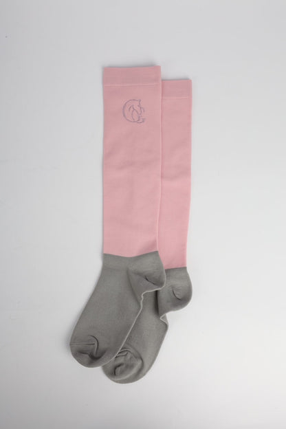 Pink and grey socks with a logo on a light grey background
